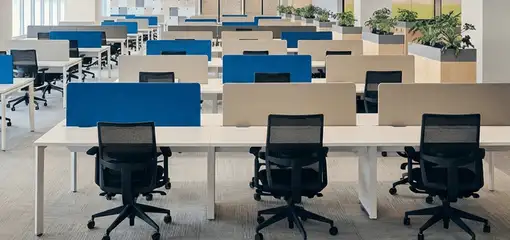 Modern open-plan office space featuring clean workstations, ergonomic chairs, and sanitized carpets provided by professional office cleaning services in Los Angeles, CA.