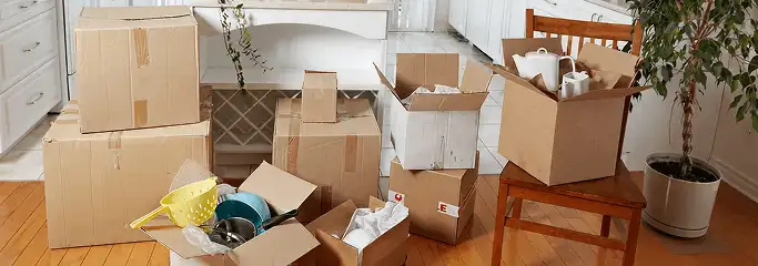 Packed moving boxes and household items in a kitchen before move-out or move-in cleaning, Los Angeles, CA.